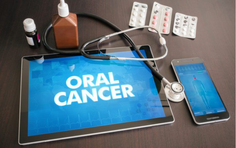 tablet that displays oral cancer with pills around it