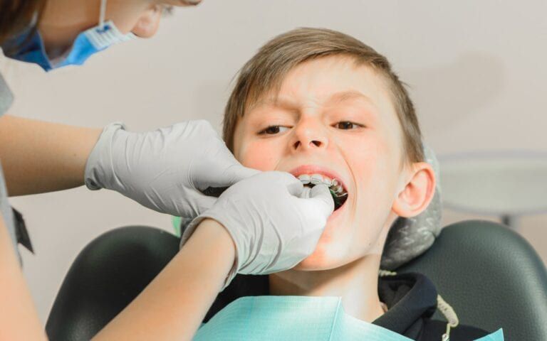 Child receiving Orthodontic Care For Protruding Teeth