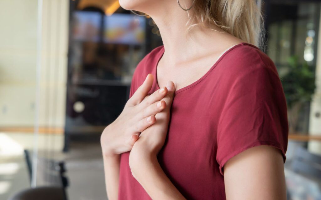 Side Profile of Woman Holding Chest From Acid Reflux