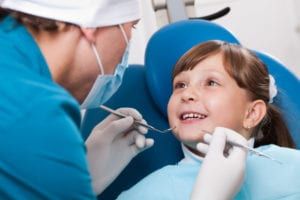 young female child undergoes dental checkup