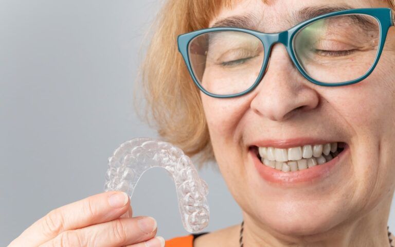 Elderly woman with clear aligner