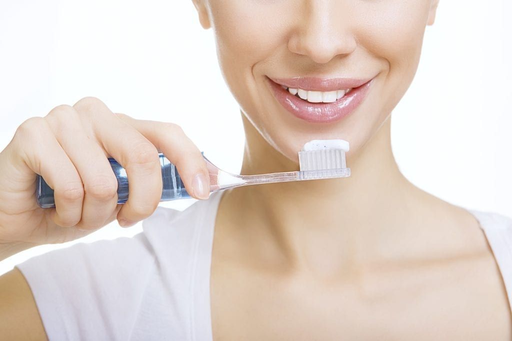 Woman brushing her teeth
