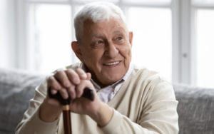 Smiling Elderly Man With Cane