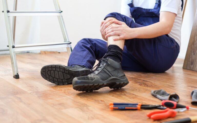 Person Experiencing Knee Injury at Workplace