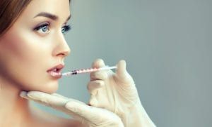 Woman looking off into the distance while getting a facial injection