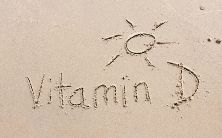 Vitamin D written in the beach