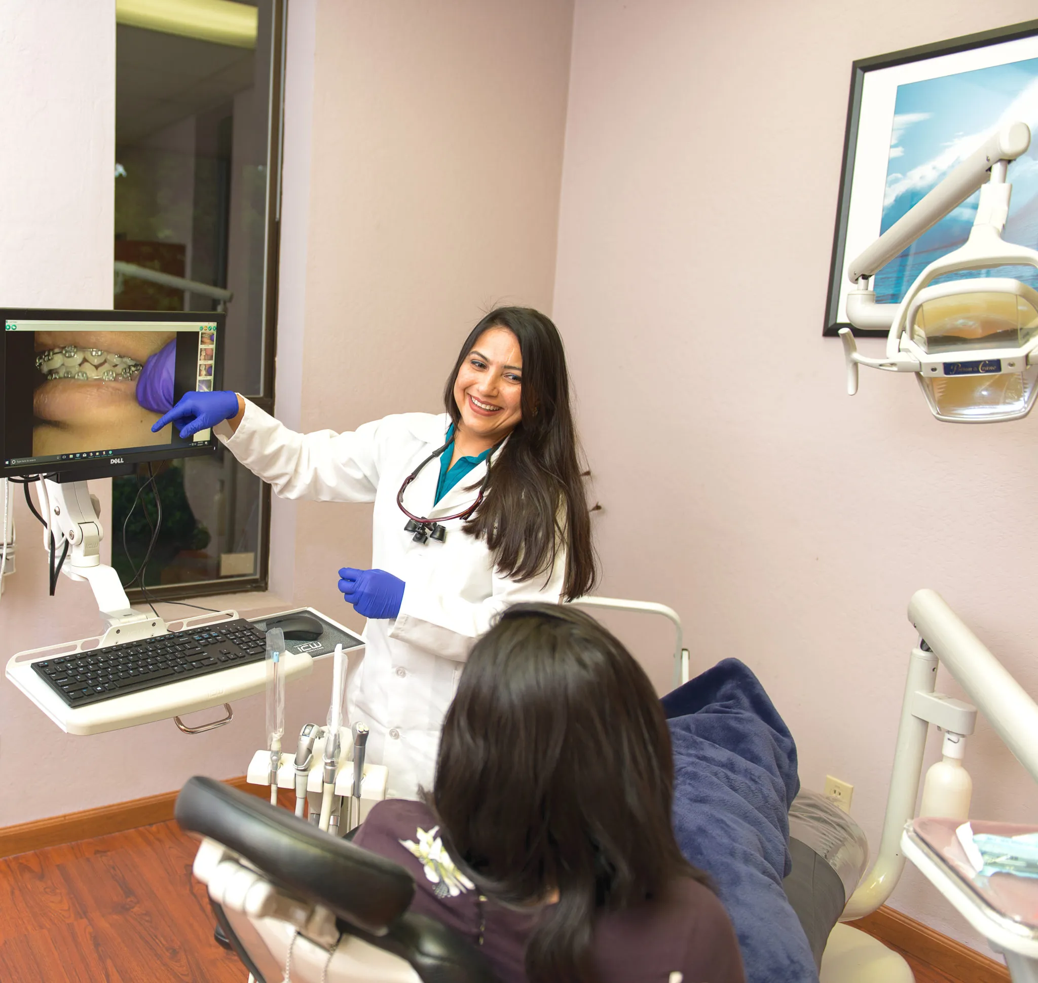 Dr. Saboowala explaining a dental procedure to her patient 10
