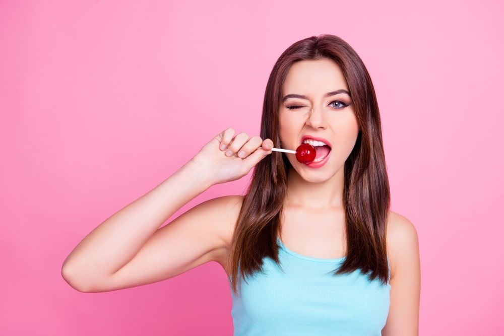 Girl biting on lollipop