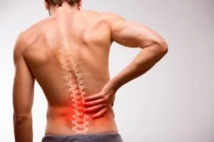 Man clutching his lower back in pain