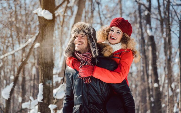 Man Carrying Woman in Winter Woods