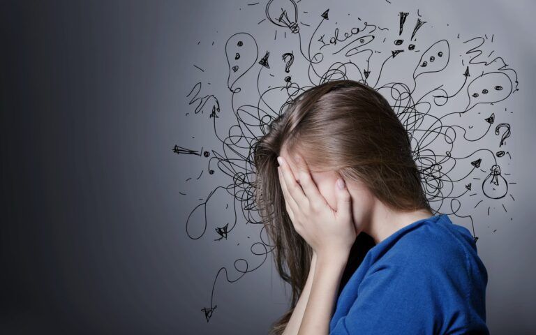 Woman experiencing a headache surrounded by black fizzy lines