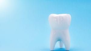 A Rendered tooth against a blue background