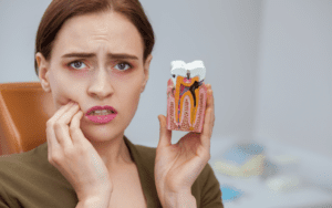 Woman holding model of decayed tooth