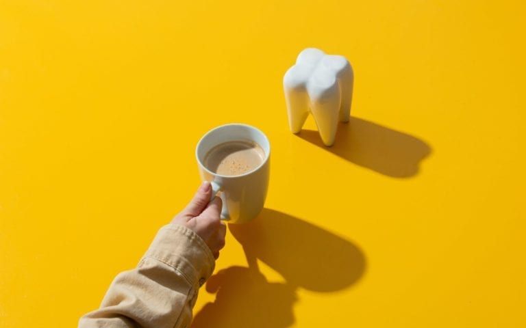 Coffee and Tooth Models on Yellow Background