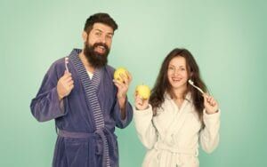 Couple with apples and toothbrushes