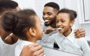 Family Brushing Their Teeth Together