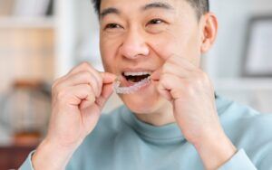 Man Caring For Invisalign Aligners