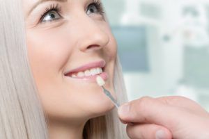 Woman having her teeth color matched for veneers