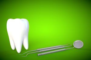 Giant tooth and dental tools on a green background
