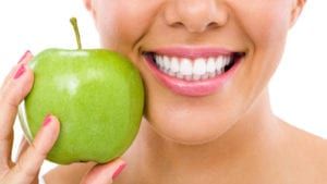 Woman Smiling Holding Green Apple
