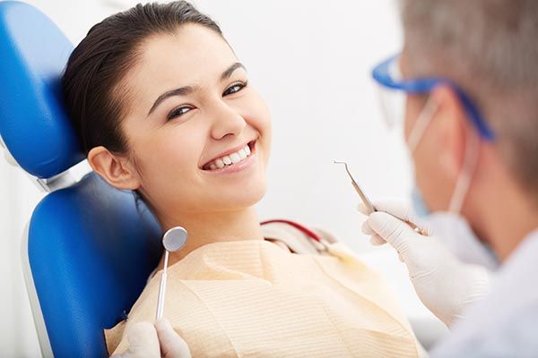 happy woman in dentist's chair