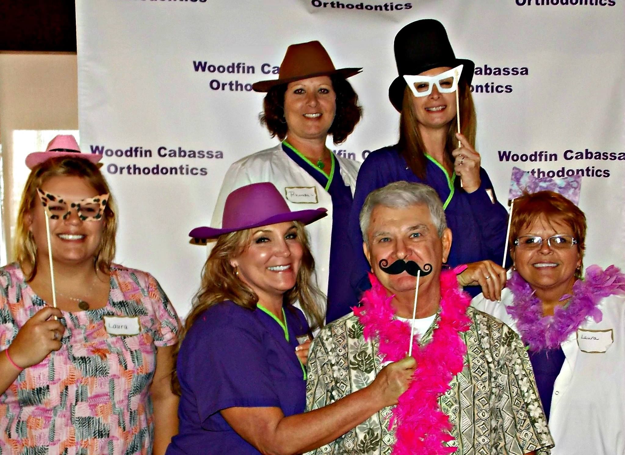 Dr. Lance Washburn and staff with photobooth props