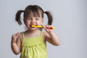 Girl brushing teeth